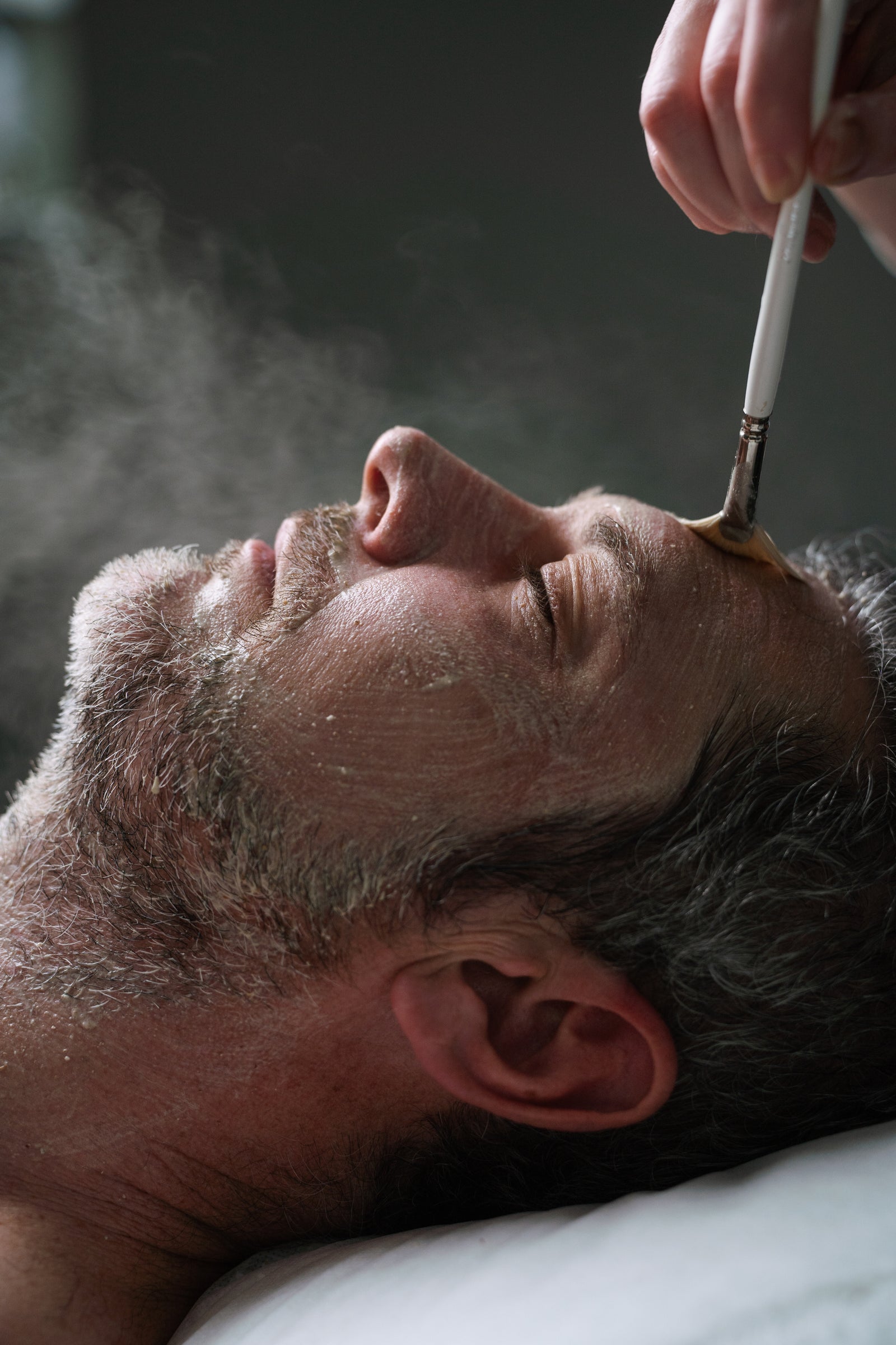 A male receiving a men's facial at Sydney's Ilumaé Skin Bar