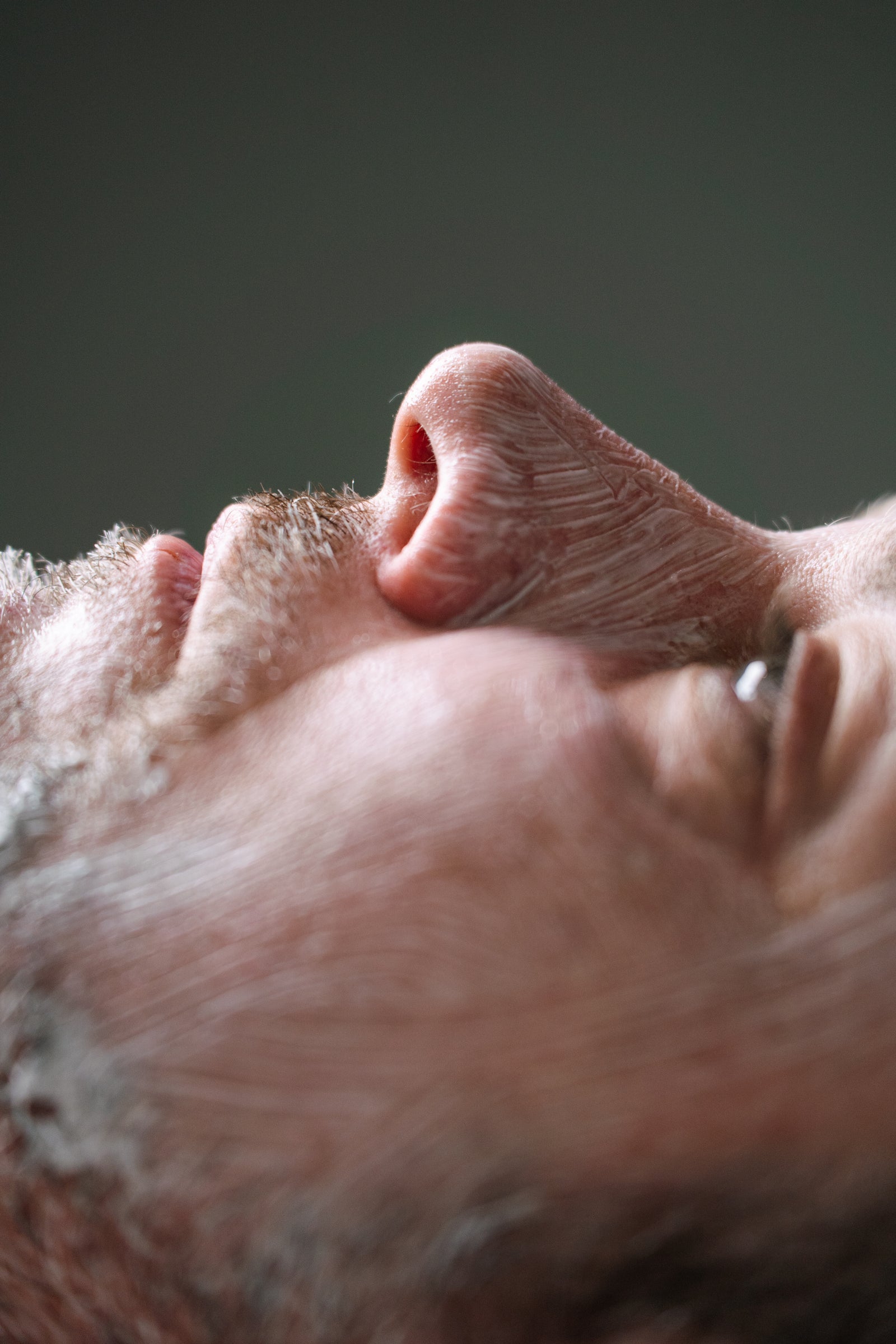 Close-up of a man's face receiving a men's facial at Sydney's Ilumaé Skin Bar